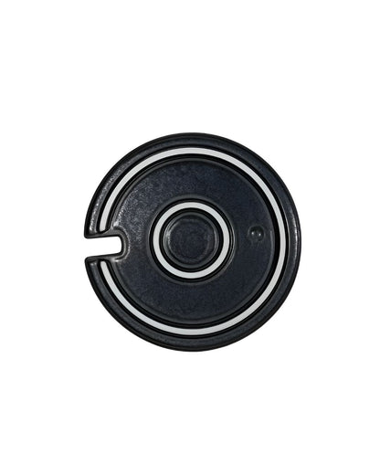 Black and silver circular object on a white background