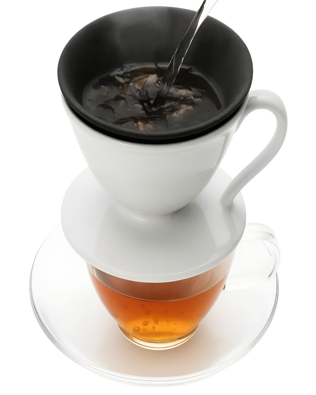 White tea filter with black lid being used to steep tea into a glass cup on a white background