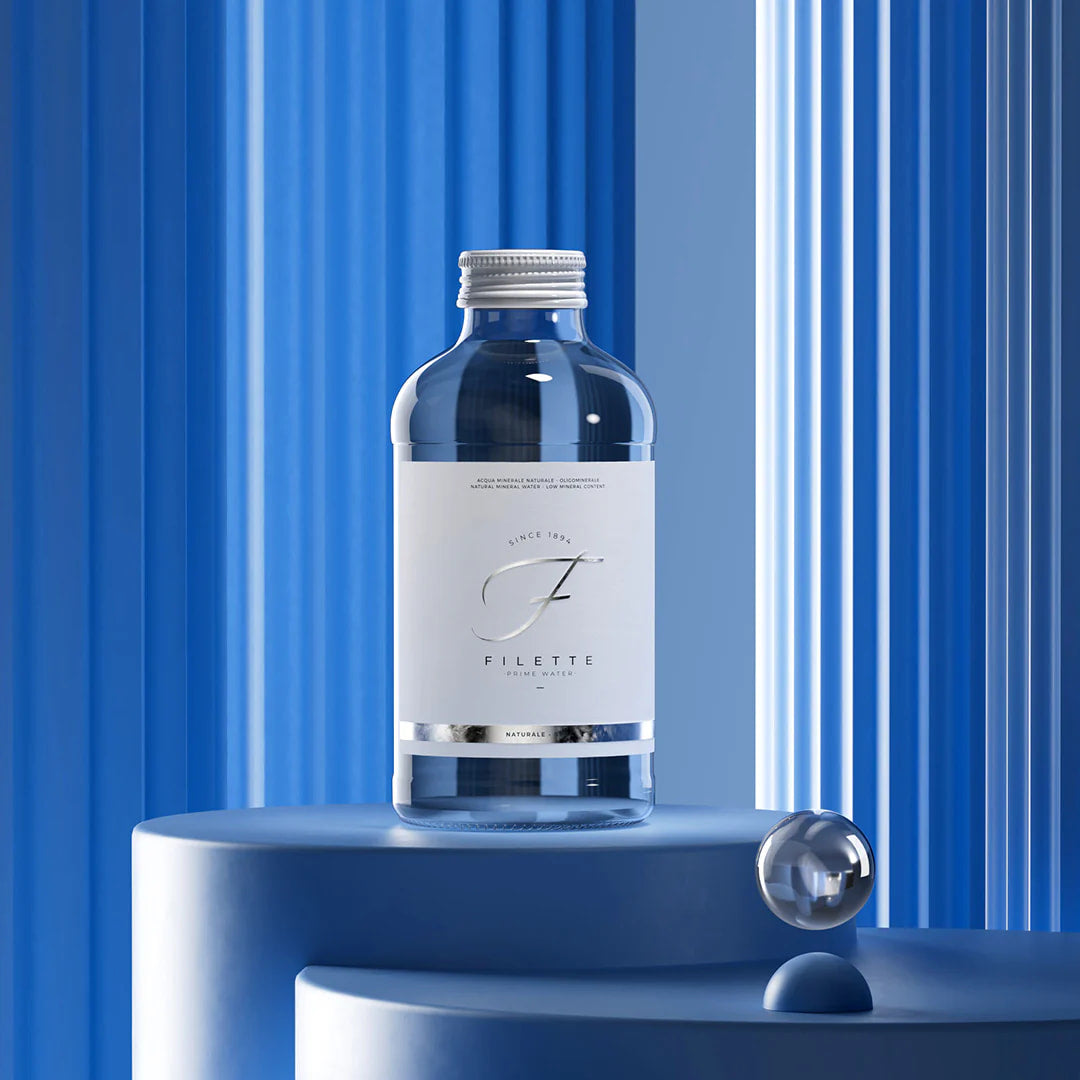 Blue bottle with a label on a blue pedestal against a blue striped background