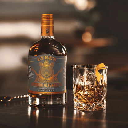 Bottle of Lyre's Non-Alcoholic Whiskey with a glass on a bar counter