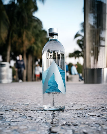 Vellamo sparkling spring water bottle placed outdoors on a city walkway